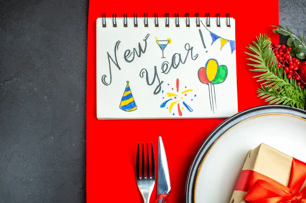Top view of a table with cutlery and a new year greeting highlighting the new year resolution diet